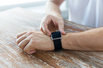 Image showing close up of male hands setting smart watch