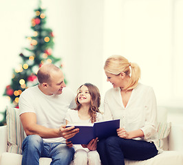 Image showing happy family with book at home