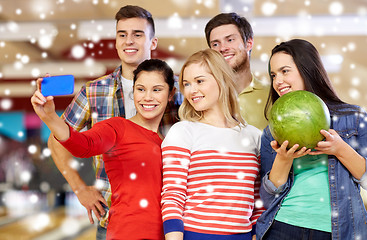 Image showing happy friends with smartphone in bowling club