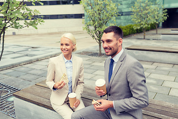 Image showing smiling businessmen with paper cups outdoors