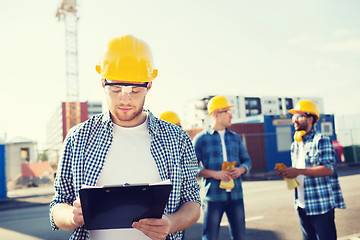 Image showing group of builders in hardhats outdoors