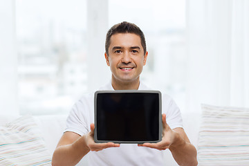 Image showing smiling man showing tablet pc blank screen at home