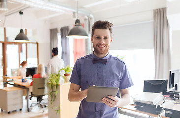 Image showing happy creative male office worker with tablet pc