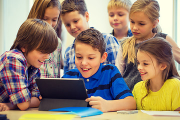 Image showing group of school kids with tablet pc in classroom