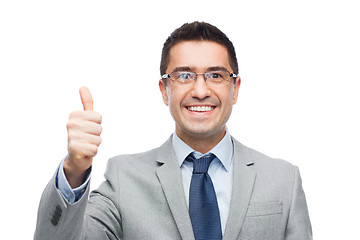 Image showing happy businessman in eyeglasses showing thumbs up