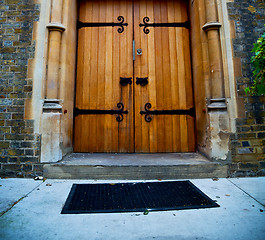 Image showing wooden parliament in london old church door and marble antique  