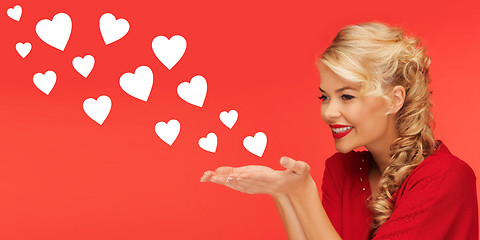 Image showing woman sending heart shapes from palms of her hands