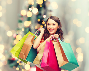 Image showing smiling woman with colorful shopping bags