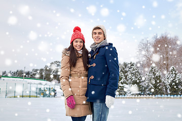 Image showing happy couple ice skating on rink outdoors