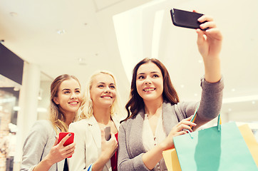 Image showing women with smartphones shopping and taking selfie