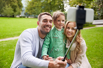 Image showing happy family taking selfie by smartphone outdoors