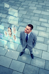 Image showing young smiling businessman outdoors from top