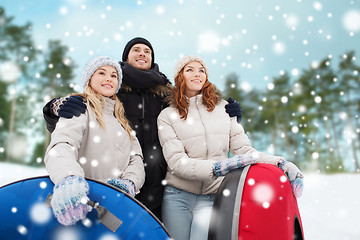 Image showing group of smiling friends with snow tubes