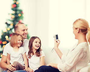 Image showing happy family with camera at home