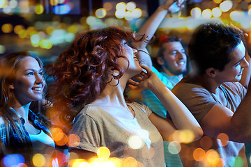 Image showing happy friends dancing at night club