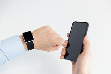 Image showing close up of hands with smart phone and watch