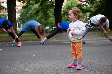Image showing jogging people group have fun with baby girl