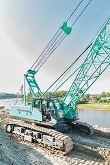 Image showing Attractive girl controls construction crane