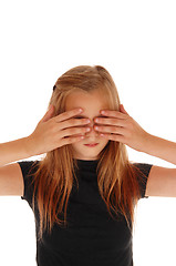 Image showing Blond girl holding her hands over eye\'s. 