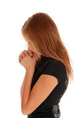 Image showing Girl standing in profile and praying.