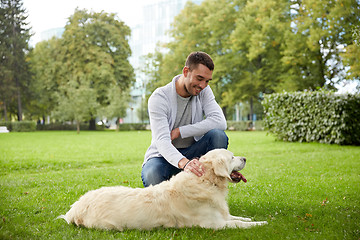 Image showing happy man with labrador dog walking in city