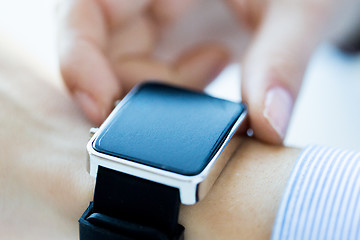 Image showing close up of hands setting smart watch