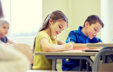 Image showing group of school kids writing test in classroom