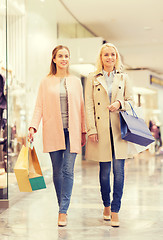 Image showing happy young women with shopping bags in mall