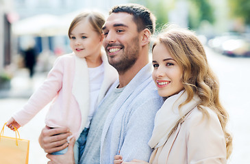 Image showing happy family with child and shopping bags in city