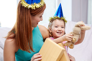 Image showing happy mother and little girl with gift at home