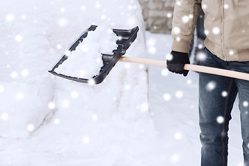 Image showing closeup of man digging snow with shovel near car