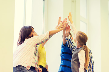 Image showing group of school kids making high five gesture