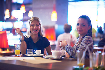 Image showing girls have cup of coffee in restaurant