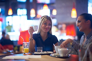 Image showing girls have cup of coffee in restaurant