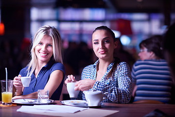 Image showing girls have cup of coffee in restaurant