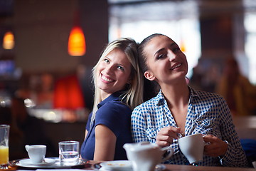 Image showing girls have cup of coffee in restaurant