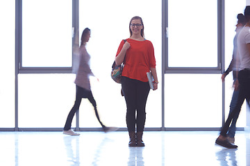 Image showing student girl standing with laptop, people group passing by