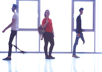 Image showing student girl standing with laptop, people group passing by