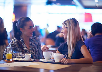 Image showing girls have cup of coffee in restaurant