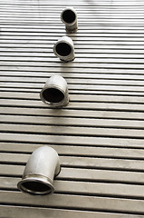 Image showing Pipes in a metal floor