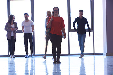 Image showing student girl standing with laptop, people group passing by