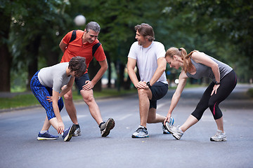 Image showing jogging people group stretching