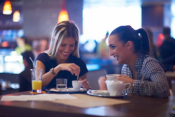 Image showing girls have cup of coffee in restaurant