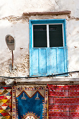 Image showing blue window in   africa old  brown wall red carpet