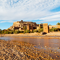 Image showing sunset in africa old construction near the river blue