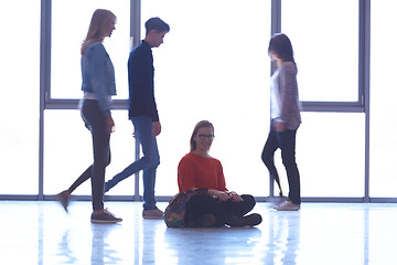 Image showing student girl standing with laptop, people group passing by