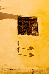 Image showing   yellow window in morocco   construction  brown wall  