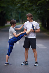 Image showing jogging couple stretching