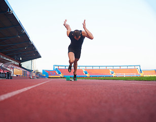 Image showing pixelated design of woman  sprinter leaving starting blocks