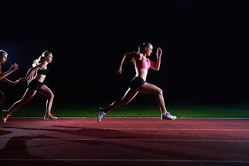 Image showing athletic runners passing baton in relay race